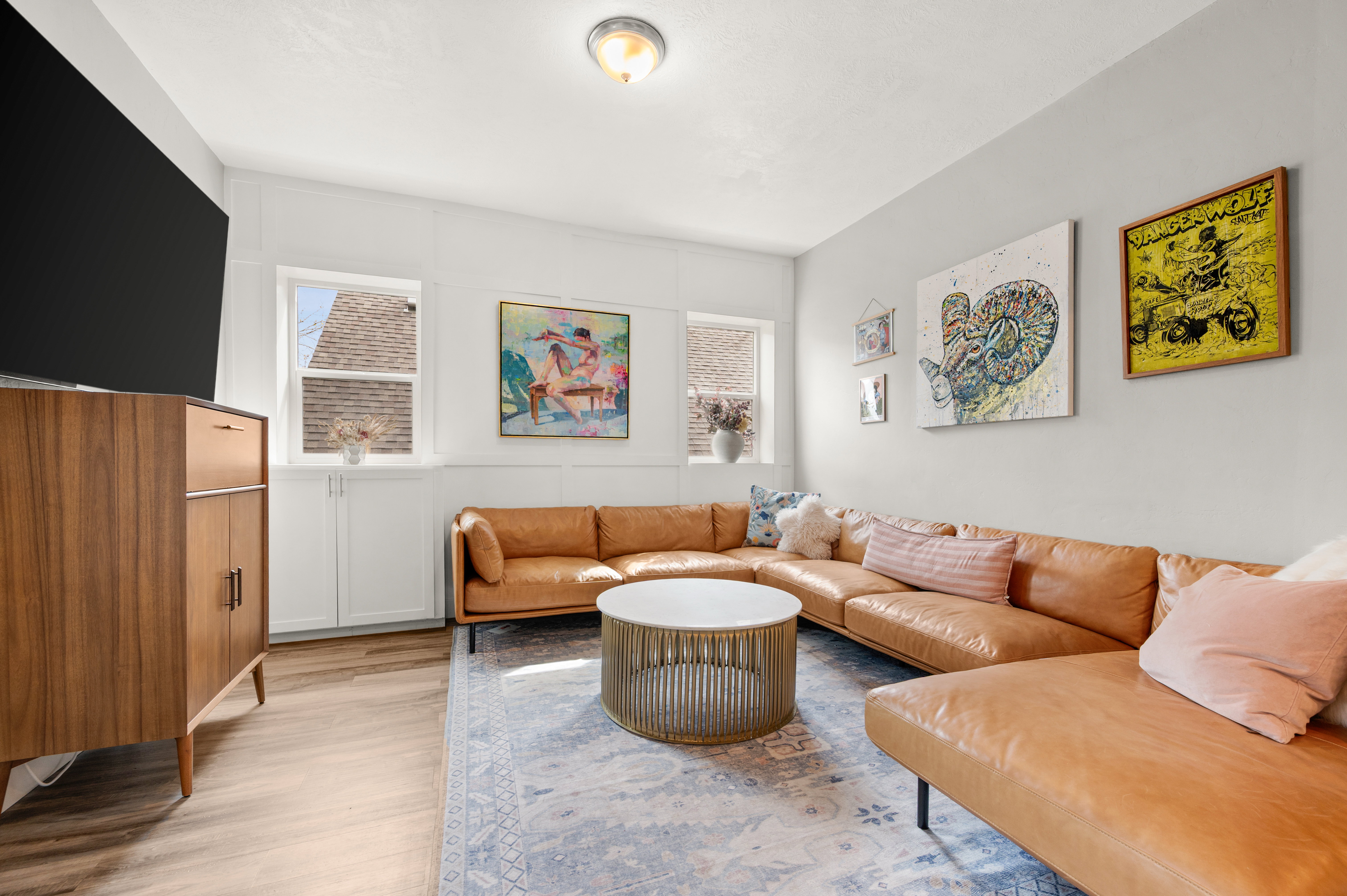 Living area featuring light wood-type flooring and a decorative wall