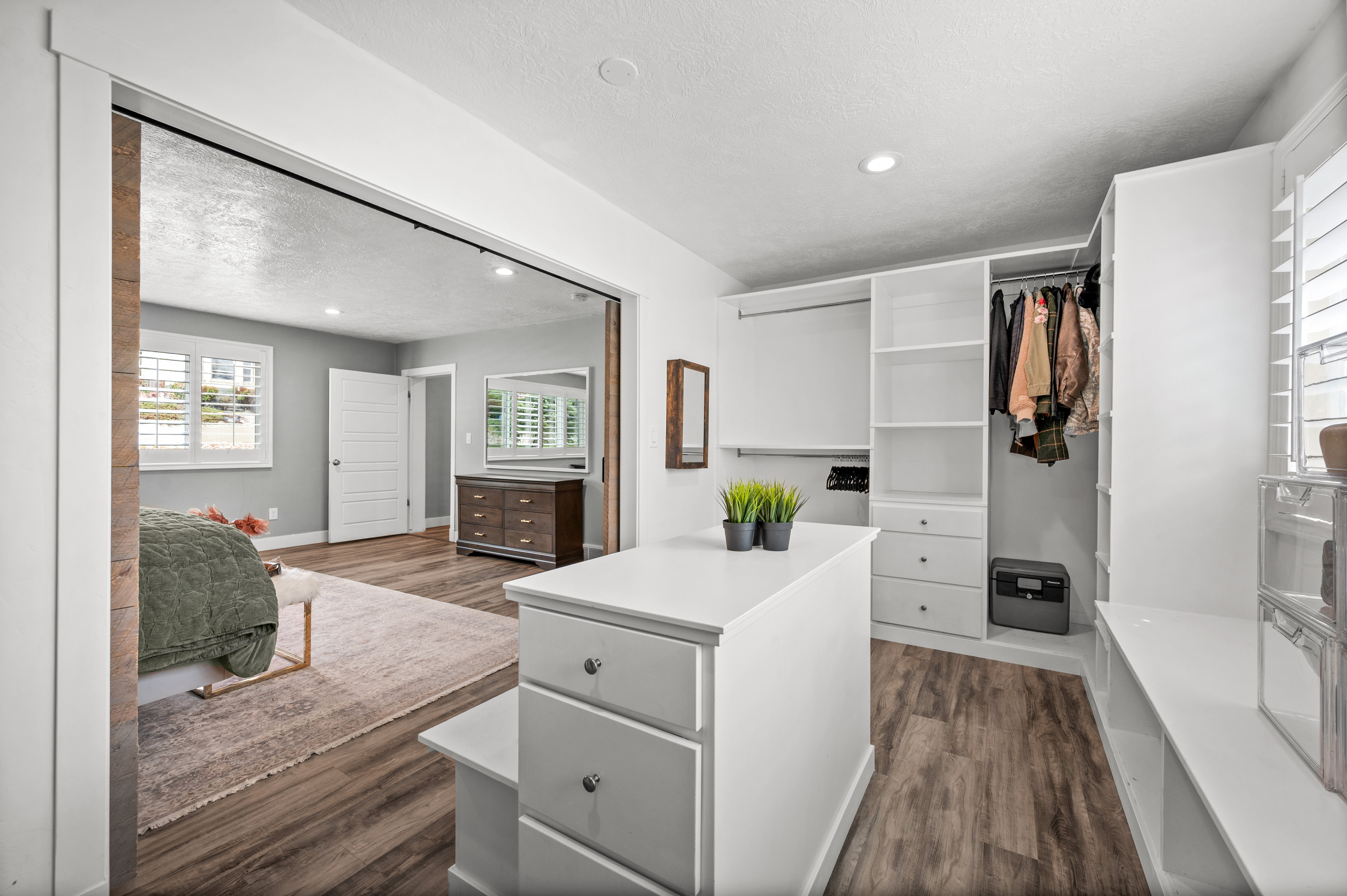 Walk in closet with dark wood finished floors