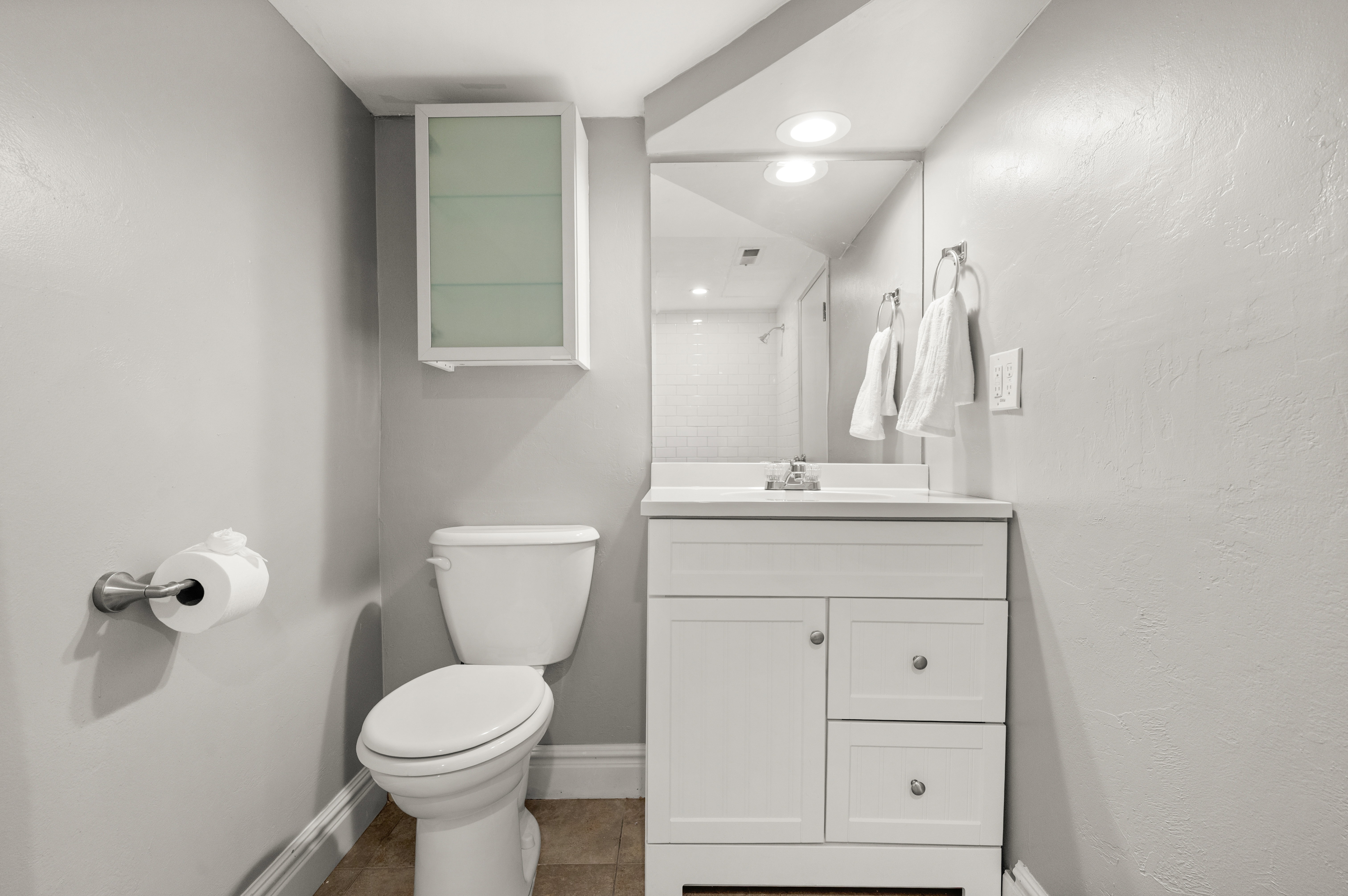 Bathroom with vanity, light tile patterned floors, a shower, and recessed lighting