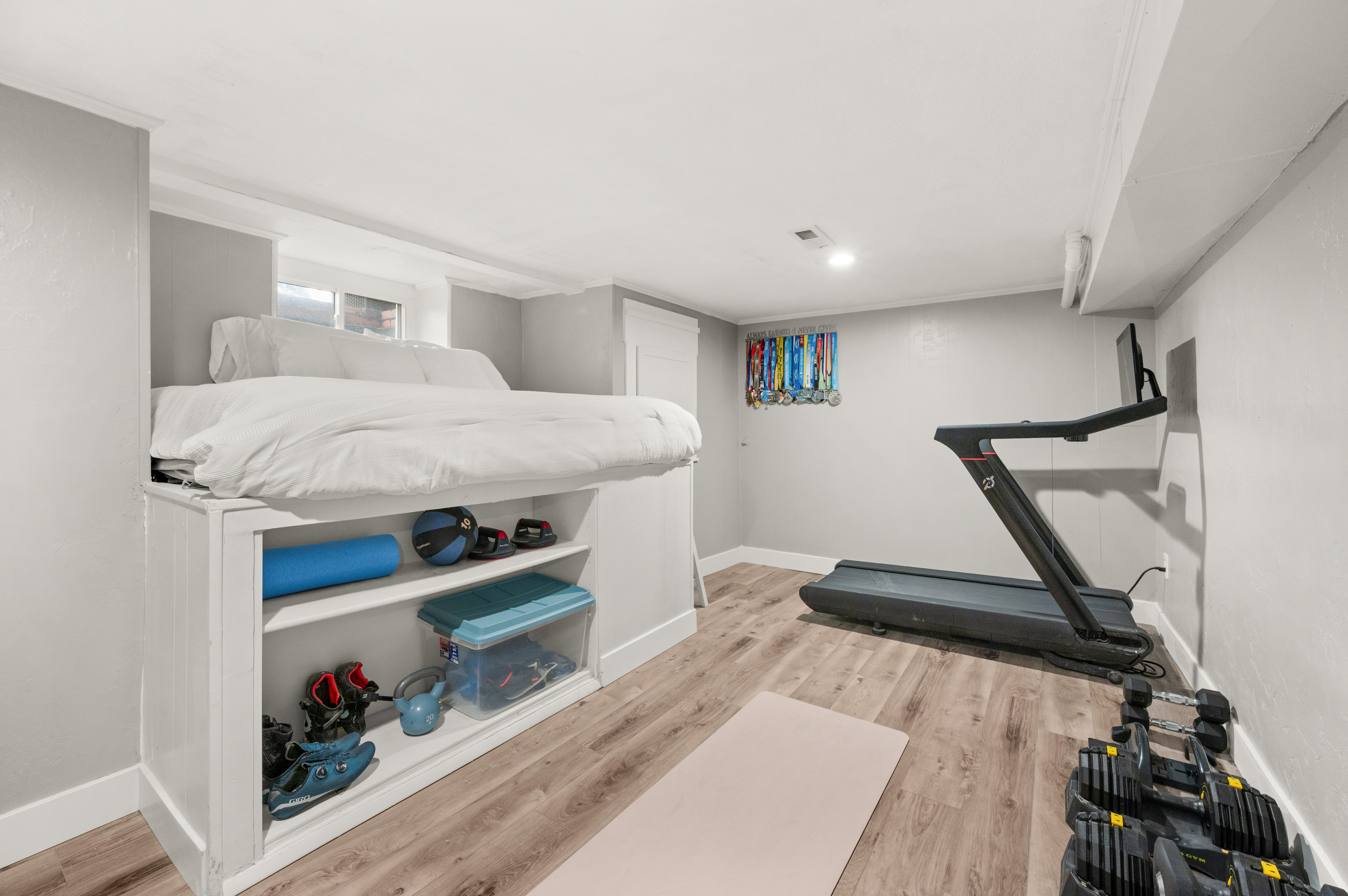 Exercise area featuring light wood finished floors and baseboards