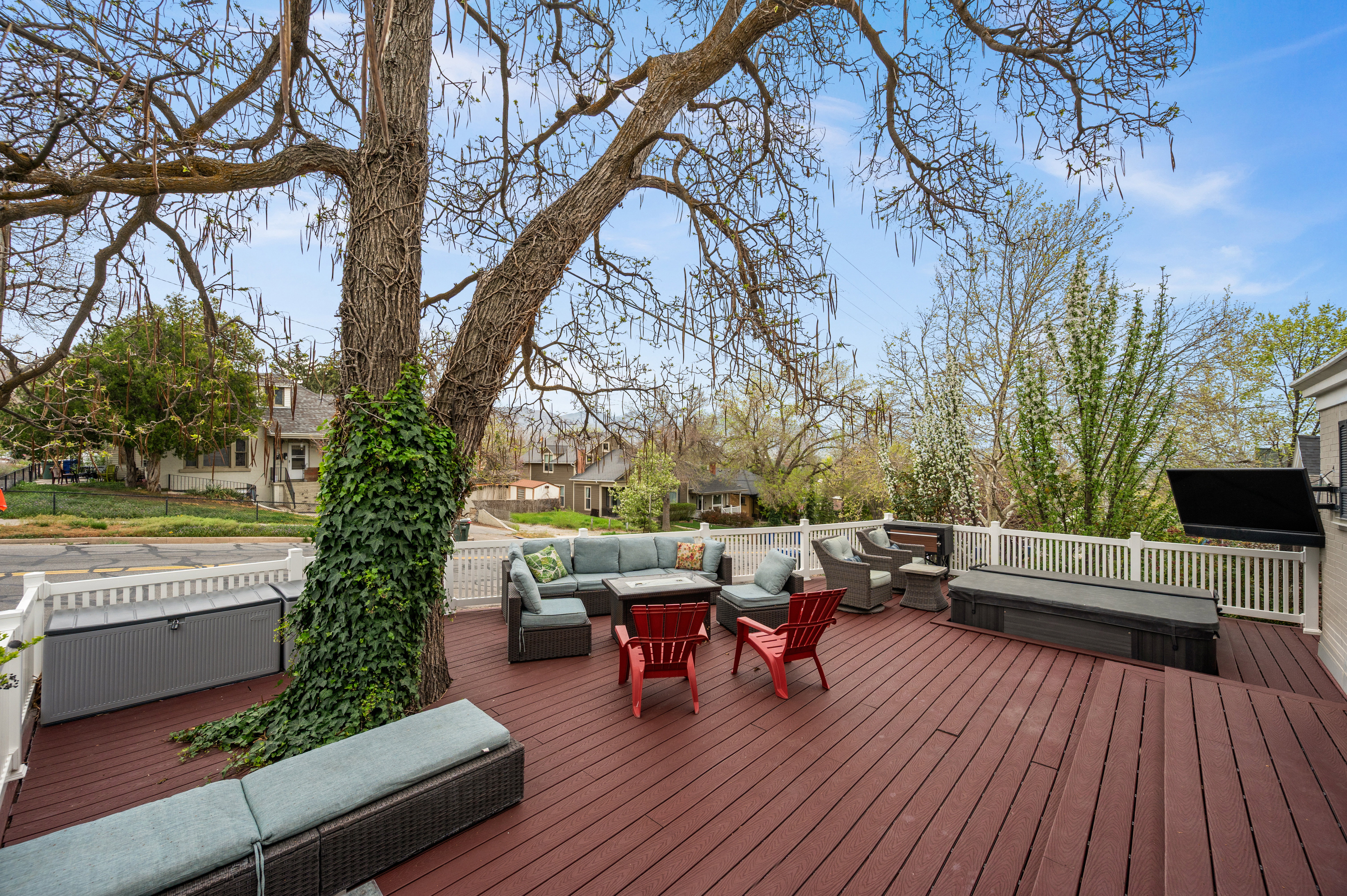 Wooden terrace featuring outdoor furniture and a covered hot tub