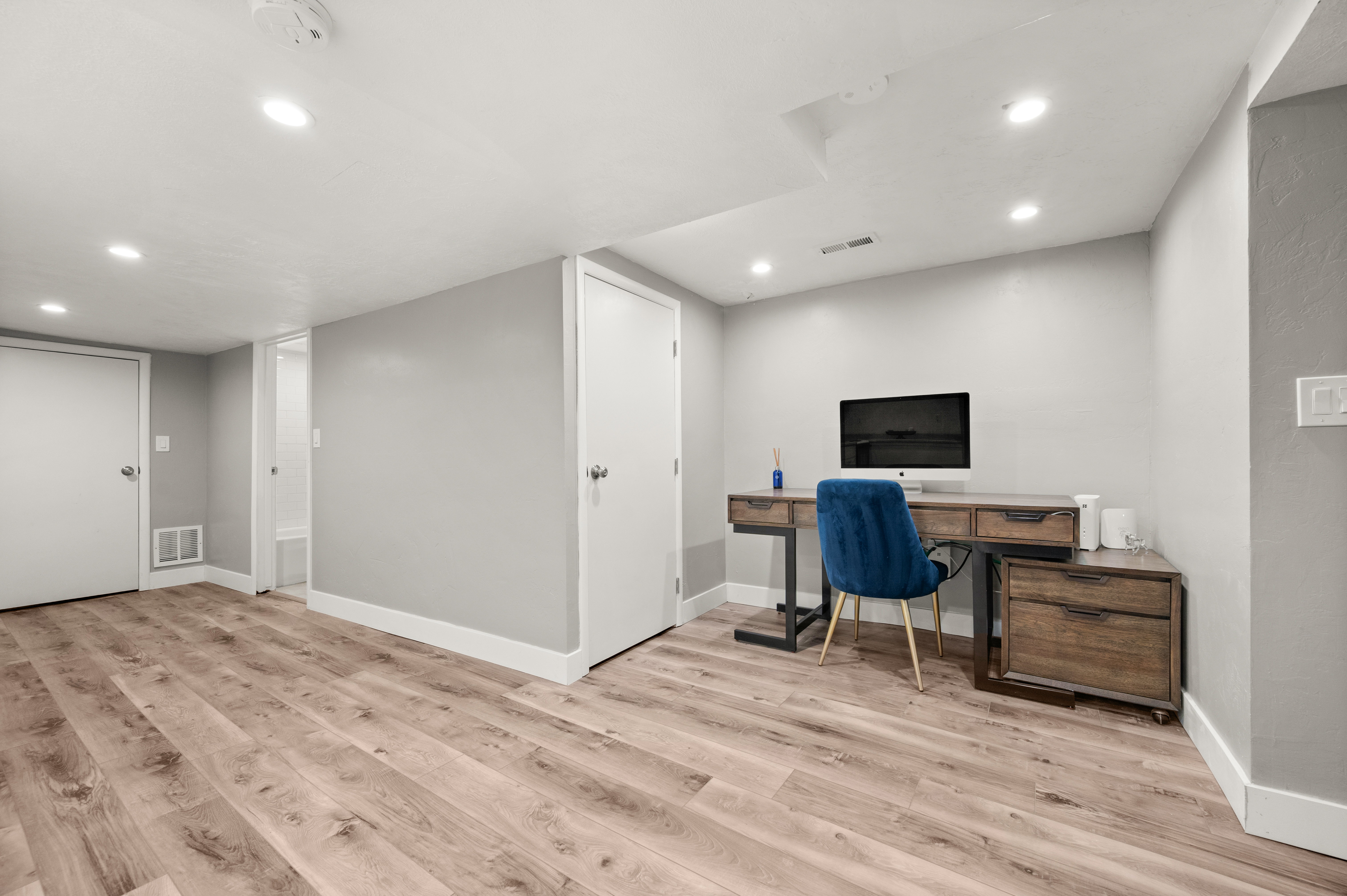 Home office featuring light wood finished floors and recessed lighting