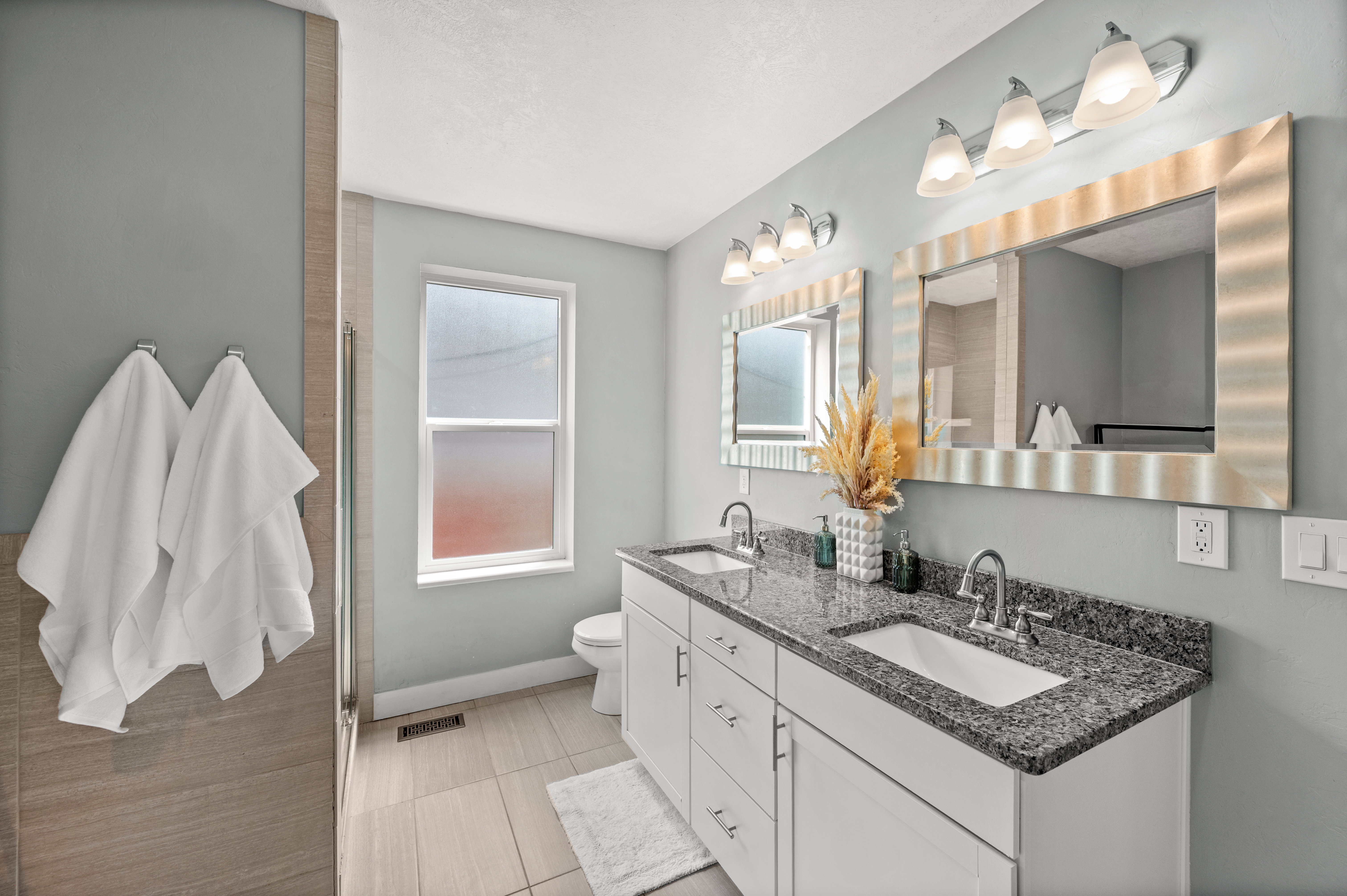 Bathroom featuring double vanity and toilet