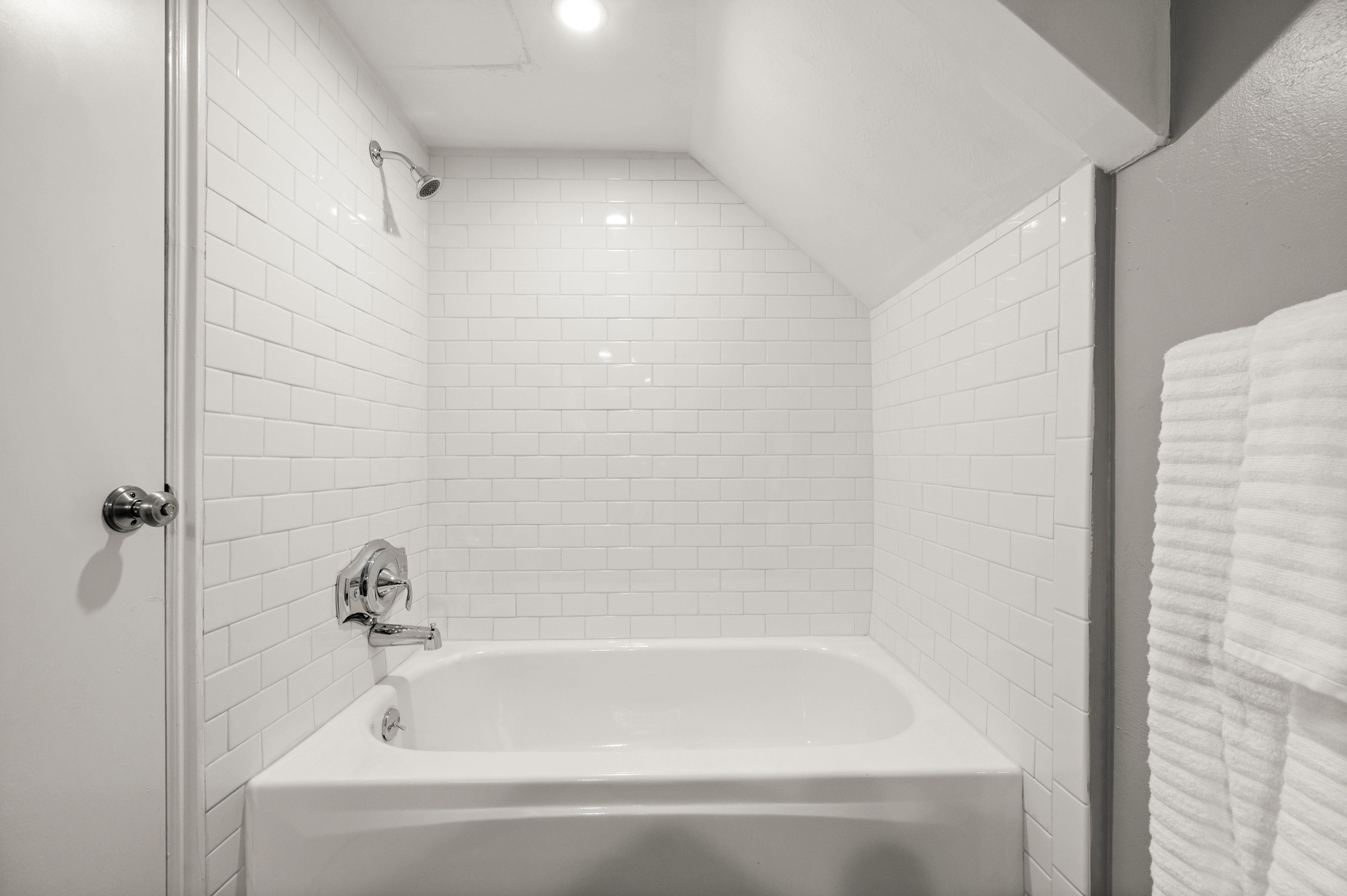 Full bath with  shower combination and vaulted ceiling