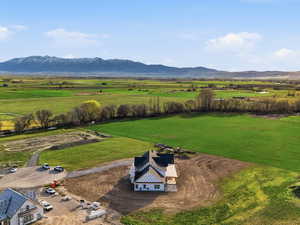 Aerial view of sparsely populated area featuring a mountain backdrop and agricultural land