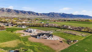 Aerial view of property and surrounding area featuring a mountainous background