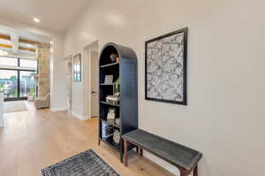 Corridor featuring light wood finished floors and recessed lighting