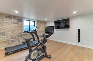 Workout room featuring light wood-type flooring and recessed lighting