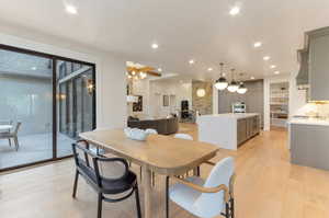Dining room featuring light wood-style flooring and suspended lighting