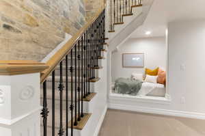 Stairway featuring carpet floors and baseboards