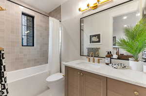 Full bathroom featuring vanity and shower / bath combo with shower curtain