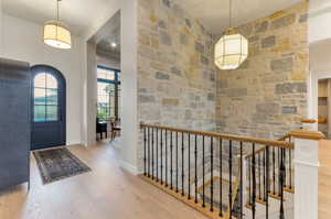 Foyer entrance with light wood finished floors and baseboards