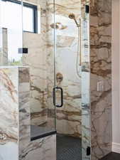 Bathroom featuring a marble finish shower