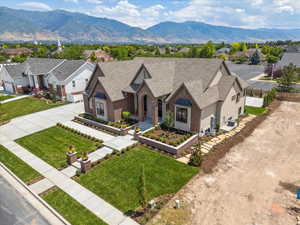 View of front of property with roof with shingles, a mountain view, a residential view, and brick siding