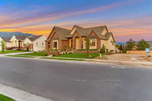 View of front of property with brick siding and a shingled roof
