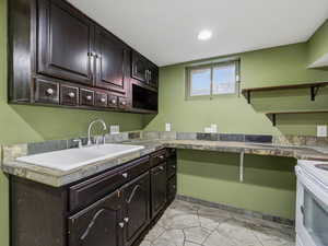 Laundry area featuring baseboards and recessed lighting