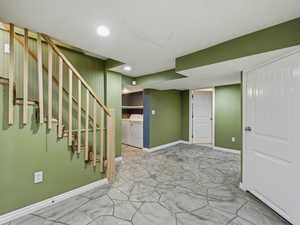 Finished basement with washer and dryer and recessed lighting