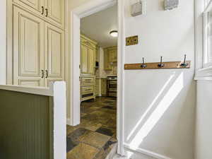 Bathroom with stone tile flooring and tasteful backsplash