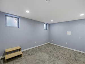 Below grade area with recessed lighting and baseboards