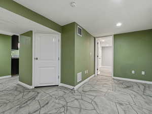 Finished basement with baseboards and recessed lighting