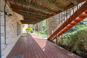 Lower wooden deck with basement access.