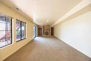 Basement family room with fireplace, built in shelving and walkout door.