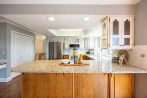 Kitchen with granite countertops, appliances and view of the backyard.