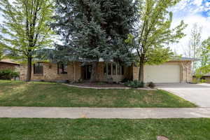 East Layton all brick rambler on wooded lot with views.