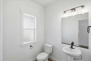 Bathroom featuring toilet and wood finished floors