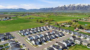 Aerial overview of property's location with nearby suburban area and a mountain backdrop