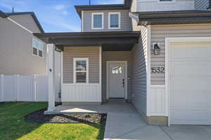 Property entrance with board and batten siding and a porch