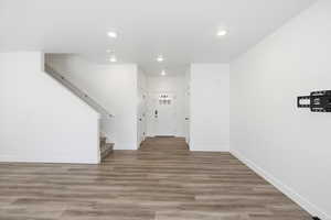 Unfurnished living room featuring light wood-type flooring and recessed lighting