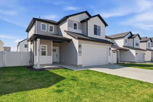 View of front of property featuring a gate, driveway, a garage, and a shingled roof