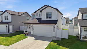 Traditional home featuring driveway, a residential view, a gate, and an attached garage