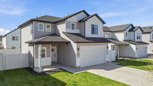 View of front of property featuring a shingled roof, concrete driveway, an attached garage, and a residential view