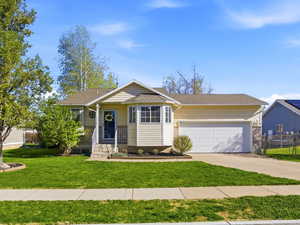 Ranch-style house featuring driveway and an attached garage