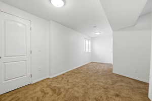Below grade area featuring carpet floors and baseboards