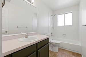 Bathroom with vanity and shower / washtub combination