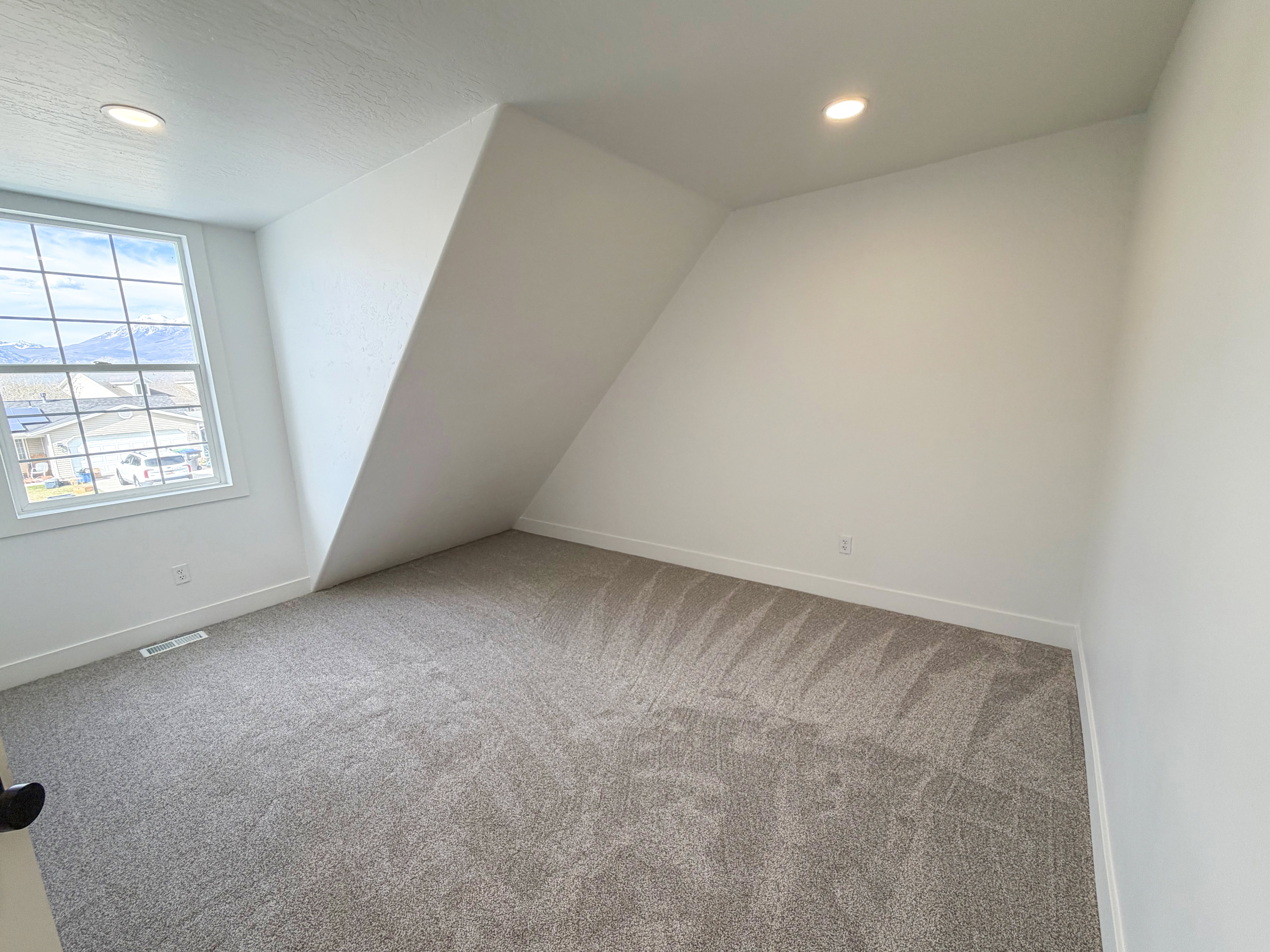 Additional living space with light carpet, recessed lighting, and vaulted ceiling