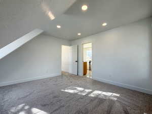 Bonus room with carpet and recessed lighting