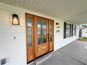 Doorway to property featuring a porch