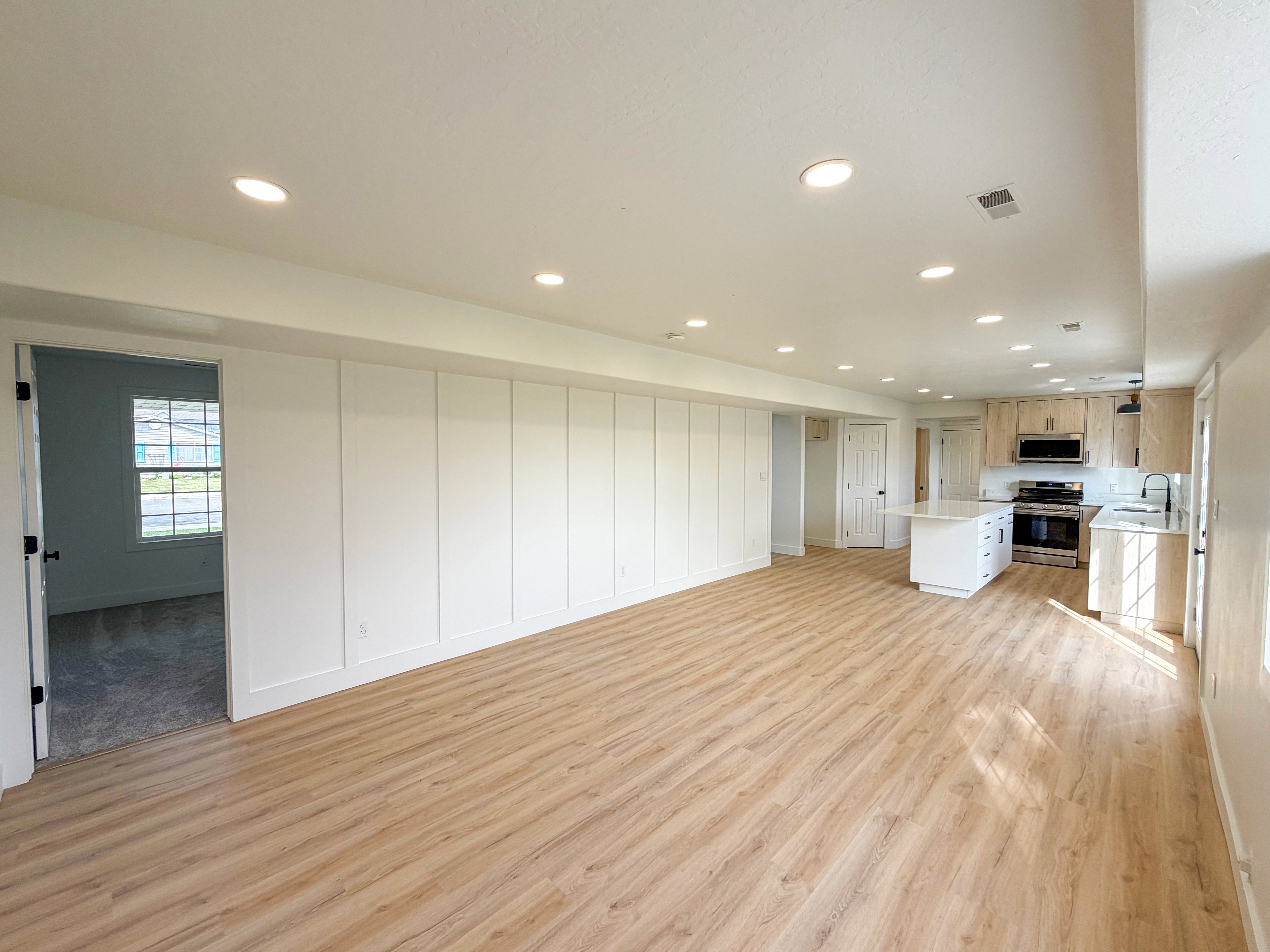 Unfurnished living room with light wood-type flooring and recessed lighting
