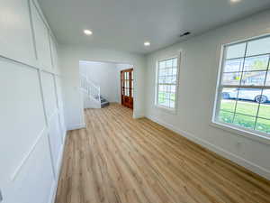 Spare room with light wood finished floors, recessed lighting, and french doors