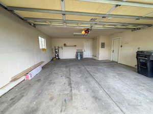 Garage featuring electric panel and a garage door opener