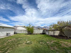 Fenced backyard featuring a mountain view