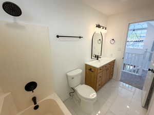 Bathroom with vanity, shower / bath combination, and light marble finish floors