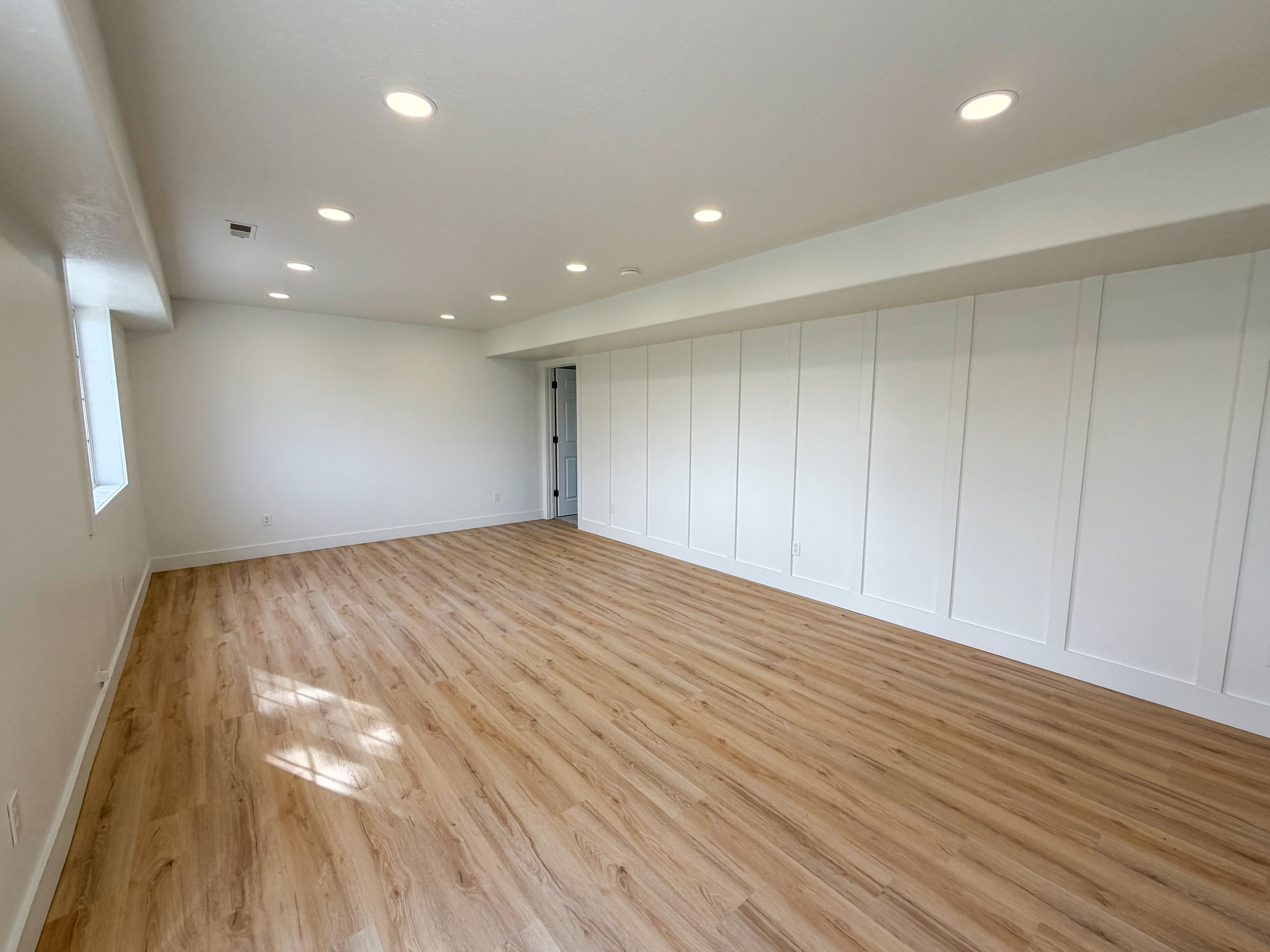 Basement featuring light wood-type flooring and recessed lighting