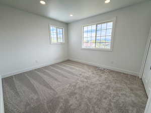 Spare room featuring light carpet and recessed lighting