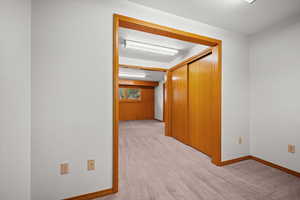 Unfurnished room featuring light colored carpet and a textured ceiling