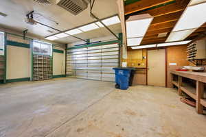 Garage featuring a workshop area and a garage door opener